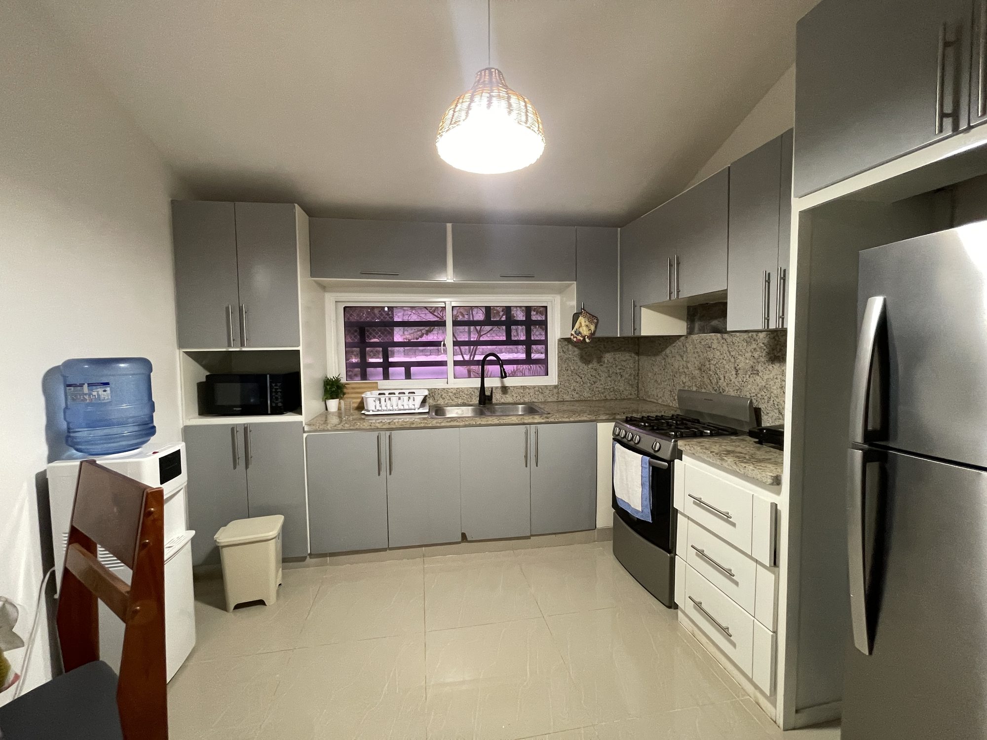 The kitchen, with a gas stove and full-size fridge