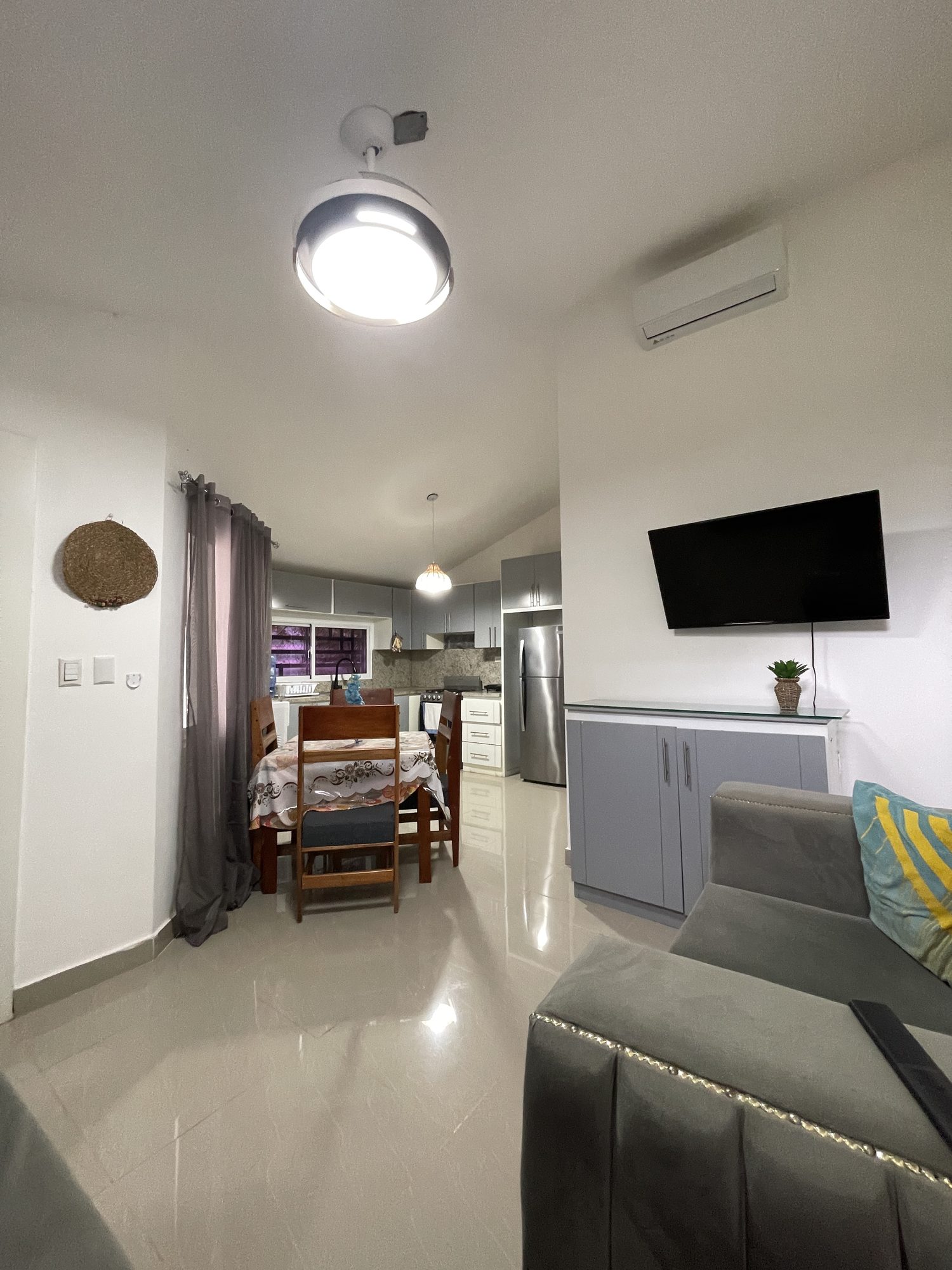 Looking across the living room to the dining table and kitchen